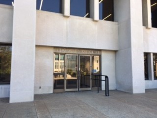 A set of doors on the exterior of the Wells Library with the label "Library & Info Sciences" above the doors